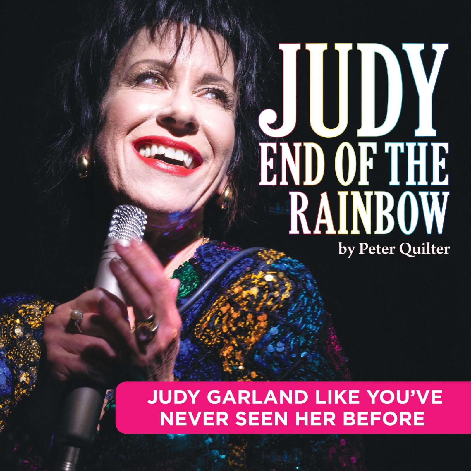 A performer with red lipstick smiles while holding a microphone. The text reads "Judy End of the Rainbow by Peter Quilter." Vibrant, dramatic stage setting.