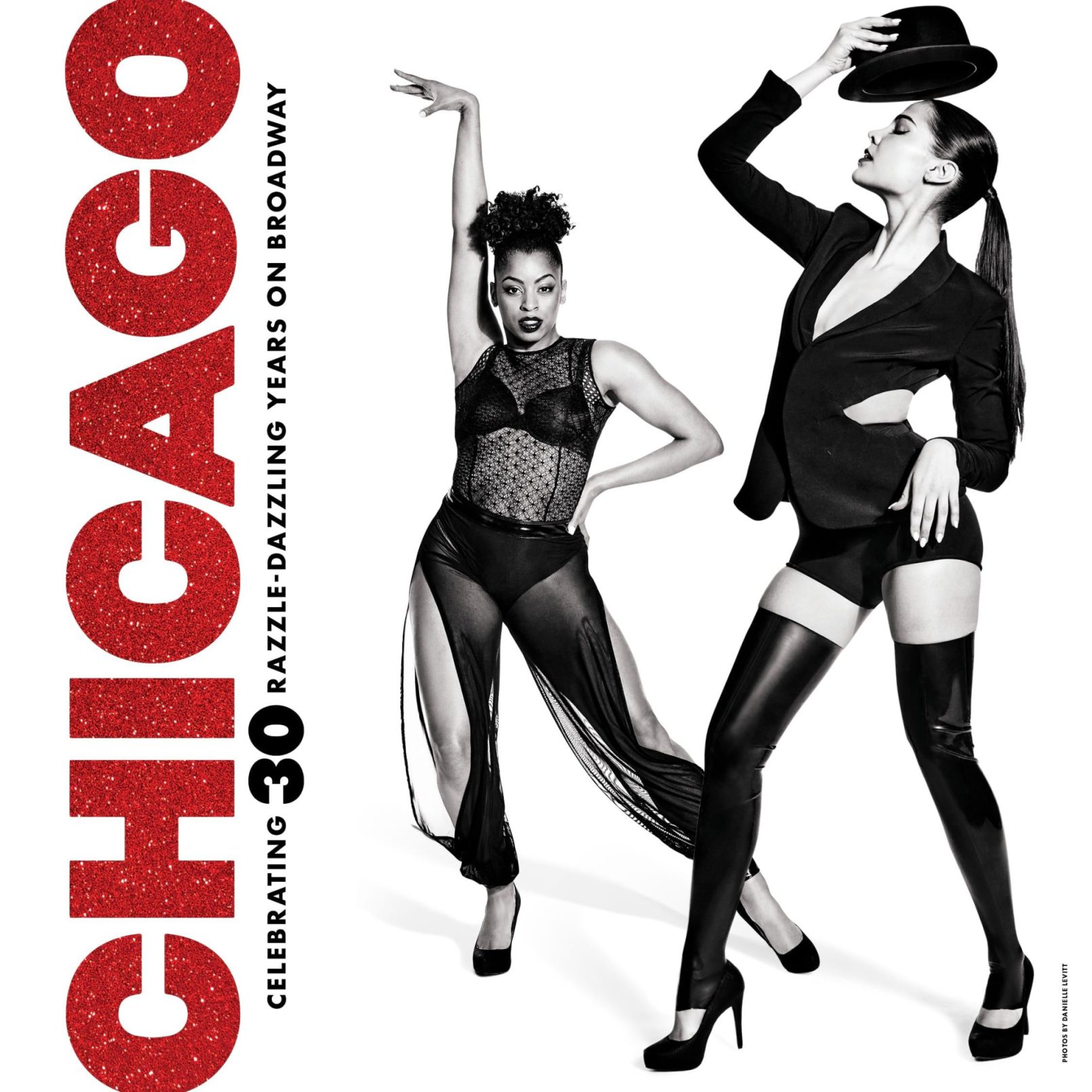 Two dancers striking poses in black attire for "Chicago" 30th Broadway anniversary poster with glittery red text.