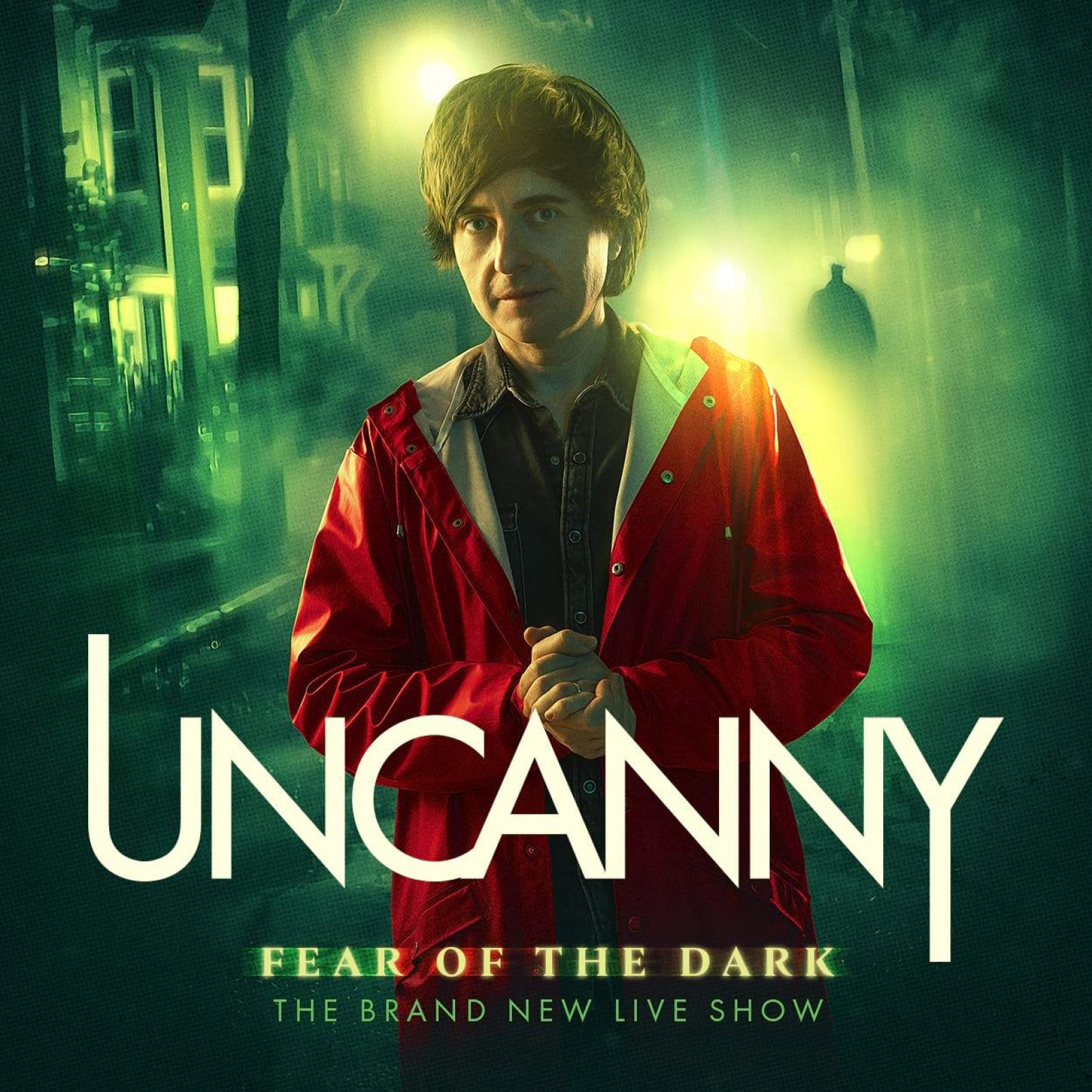 A man wearing a red jacket stands under glowing streetlights on a misty night, conveying a mysterious and eerie atmosphere. Text reads "Uncanny: Fear of the Dark, The Brand New Live Show."