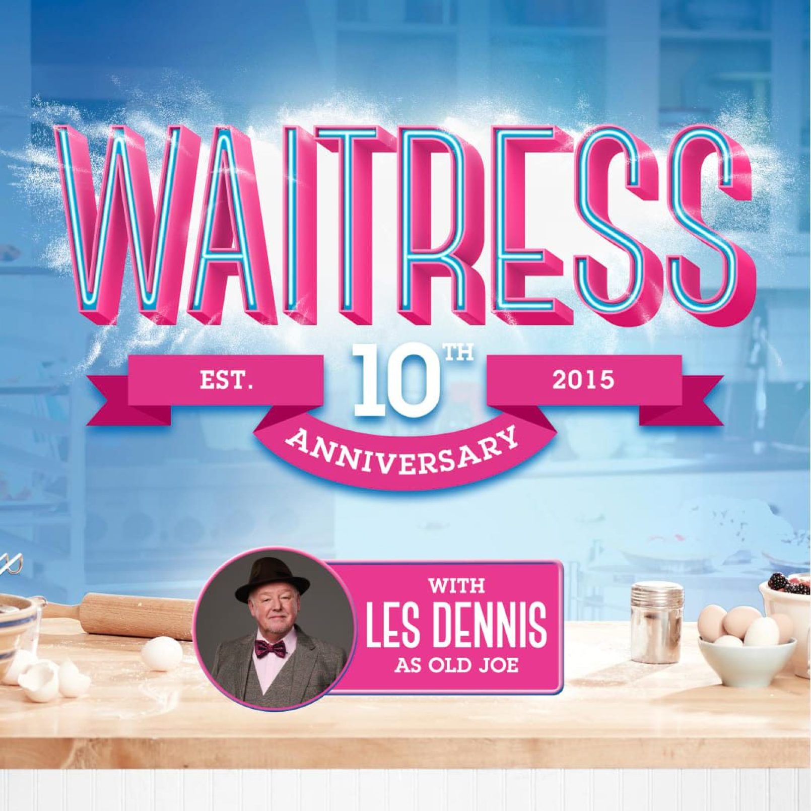 Poster for the 10th anniversary of "Waitress" with bold pink and blue text. Les Dennis is featured as Old Joe. Kitchen items like eggs and flour are visible.