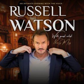 The image features a man in a suit adjusting his collar, set against an ornate, warmly lit theater background. Text reads "Russell Watson" and "With guest artist Nancy May."