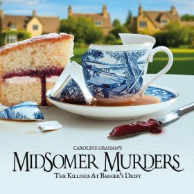 A broken blue and white teacup with a murder scene design spills tea over a saucer. A sponge cake slice and knife with red jam are beside it, with quaint countryside houses in the background. Text reads "Midsomer Murders: The Killings at Badger's Drift."