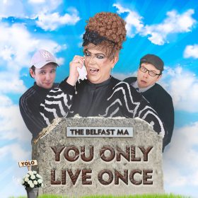 A comical scene with three people behind a tombstone. A character with curly hair and veil laughs, holding a tissue. Text on tombstone reads "You Only Live Once."