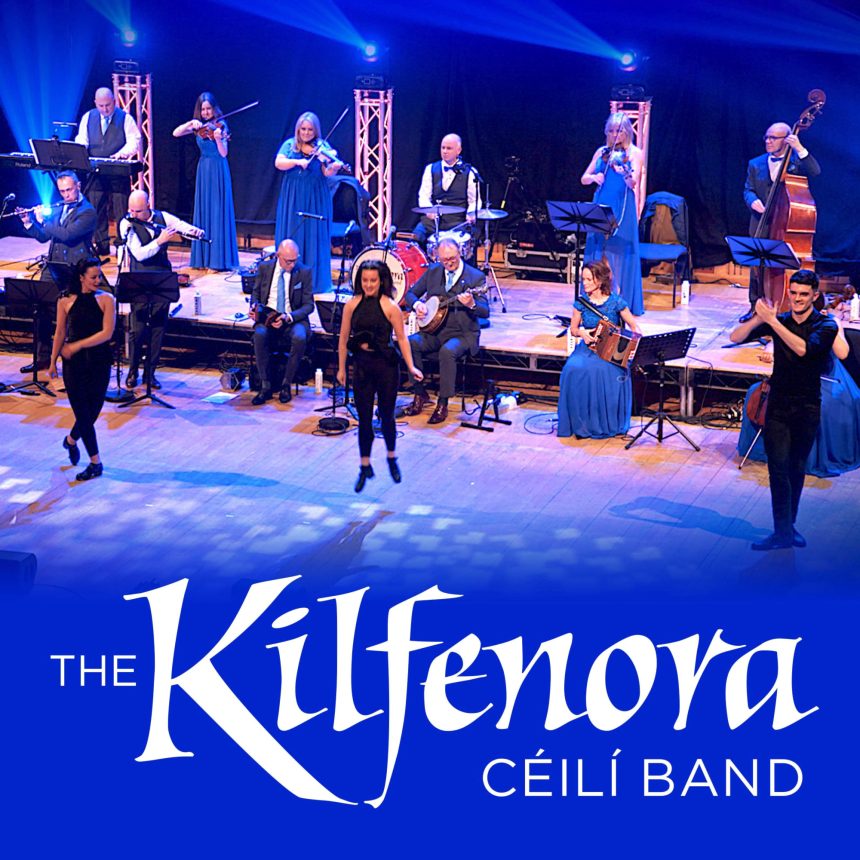 Irish band performing on stage with traditional instruments; violinists, flutist, and accordionist. Three dancers in black outfits mid-step. Text: "The Kilfenora Céilí Band."
