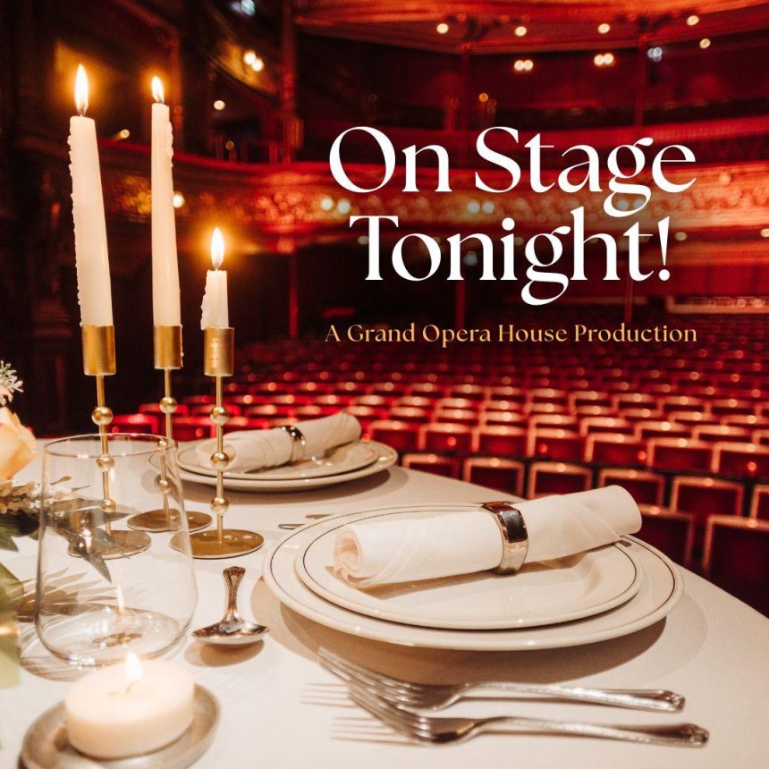 On Stage Tonight! A Grand Opera House Production

Image Description: A circular table is set for a fine dining style meal with candles and flowers as decoration. In the background is a theatre auditorium with blurred rows of red seating.