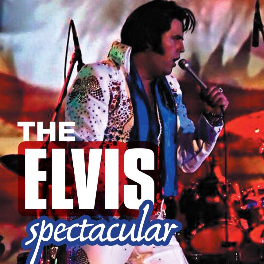 A performer dressed as Elvis sings into a microphone on stage, wearing a white, sequined jumpsuit. The text reads "The Elvis Spectacular."
