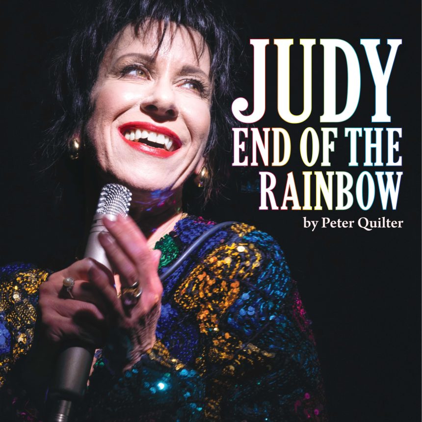 Performer smiling under spotlights, holding a microphone, wearing a colourful sequined outfit. Text reads "Judy End of the Rainbow by Peter Quilter."